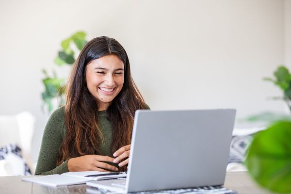 female student communicating effectively on laptop